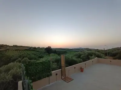 a view of the sunset from the balcony of a house at Vrachakia Stylish in Ayiá