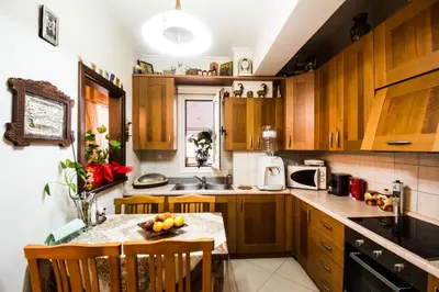 a kitchen with wooden cabinets and a table with fruit on it at Electra's House in Chania Town