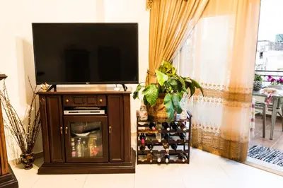 a living room with a flat screen tv and a entertainment center at Electra's House in Chania Town