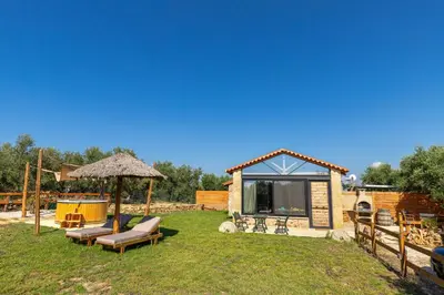 a patio with a gazebo and chairs in a yard at Villa Fabrica Baladakis adults only in Metókhi