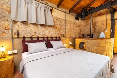 a bedroom with a large bed in a room at Villa Fabrica Baladakis adults only in Metókhi