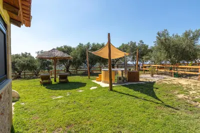 a yard with a tent and a table and chairs at Villa Fabrica Baladakis adults only in Metókhi