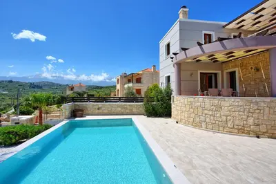 a villa with a swimming pool and a house at Villa Kostantina by PosarelliVillas in Plaka
