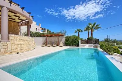 a swimming pool in front of a villa at Villa Kostantina by PosarelliVillas in Plaka