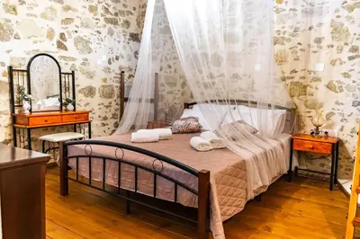 a bedroom with a bed with two towels on it at Traditional Mansion in Kaláthenai
