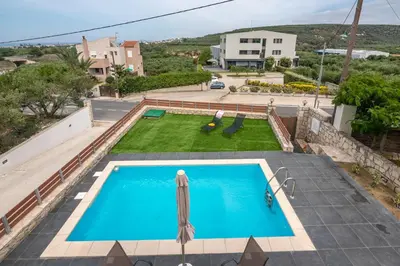 a view of a swimming pool from a house at Lithina charm villa with private pool and sea view in Kamisianá