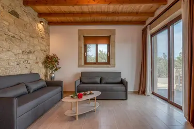 a living room with two couches and a table at Lithina charm villa with private pool and sea view in Kamisianá