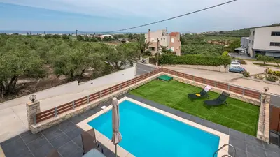 an overhead view of a swimming pool with a yard at Lithina charm villa with private pool and sea view in Kamisianá