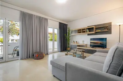 a living room with a couch and a tv at Stefanos apartment Chania in Chania Town