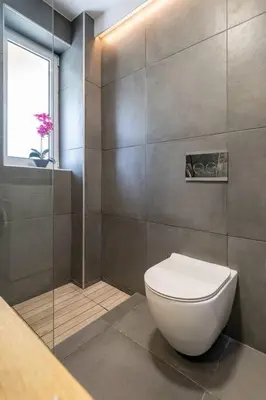 a bathroom with a white toilet and a window at Stefanos apartment Chania in Chania Town