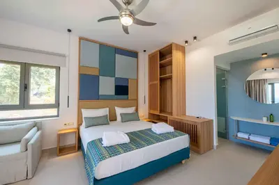 a bedroom with a bed and a bathroom with a tub at Star Luxury Villa - Private pool, gym, playground in Kato Daratso