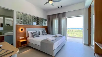 a bedroom with a large bed and a large window at Star Luxury Villa - Private pool, gym, playground in Kato Daratso