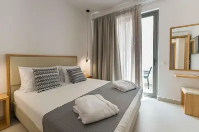 a bedroom with a bed and a large window at Star Luxury Villa - Private pool, gym, playground in Kato Daratso