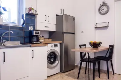 a kitchen with a table and a refrigerator at Zilina Homes2 in Chania Town