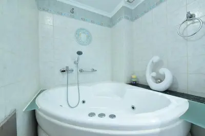 a white bathroom with a tub and a toilet at Zilina Homes2 in Chania Town