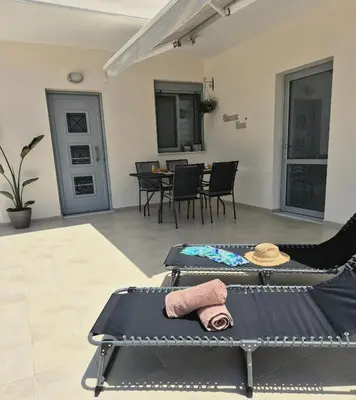 a room with a table and chairs with towels on it at Idene Penthouse in Chania Town