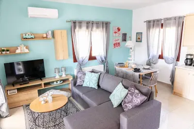 a living room with a couch and a tv at Vila Vasiliki, Next To Platanias, 6min From Sea in Vrísai