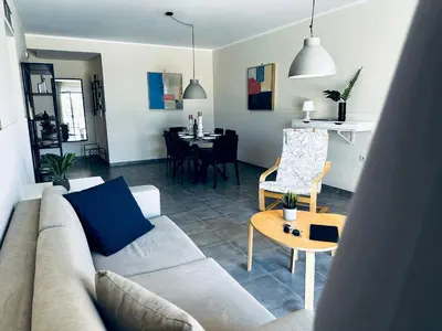 a living room with a couch and a table at lifeguard beachfront - Luxury Flat, 30meters From Sea in Stalos