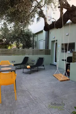 a patio with two chairs and a swing at Bellisima Campagna Cabin Pelekapina - Chania Crete in Chania Town