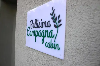 a sign on a wall with a plant on it at Bellisima Campagna Cabin Pelekapina - Chania Crete in Chania Town