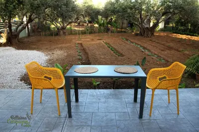 a blue table and two chairs on a patio at Bellisima Campagna Cabin Pelekapina - Chania Crete in Chania Town