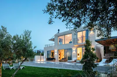 a large house with a pool in the yard at Heniochos Villas in Chania Town