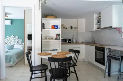 a kitchen with a table and chairs in a room at The Garden of Zephyrus - Halepa in Chania Town