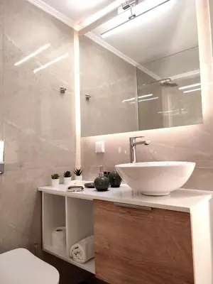 a bathroom with a sink and a mirror at The Garden of Zephyrus - Halepa in Chania Town