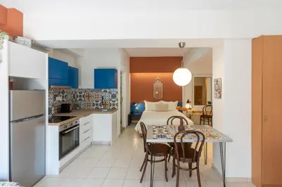 a kitchen and dining room with a bed and a table at The Garden of Zephyrus - Halepa in Chania Town