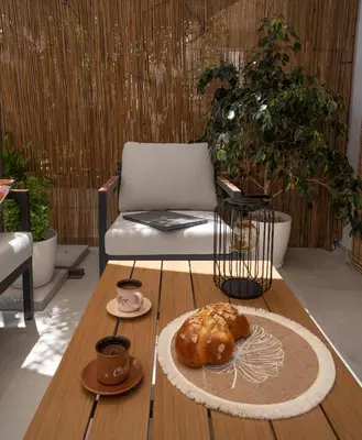 a coffee table with a pastry and cups of coffee at The Garden of Zephyrus - Halepa in Chania Town