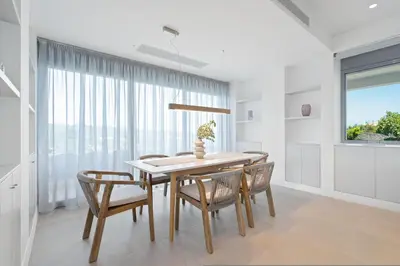 a dining room with a table and chairs and a window at Le Mont Blanc - with shared Pool in Kounoupidhianá