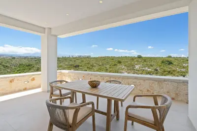 a table and chairs on a balcony with a view at Le Mont Blanc - with shared Pool in Kounoupidhianá