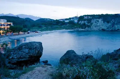 a body of water with rocks on a beach at Sia's Sea House in Almirida