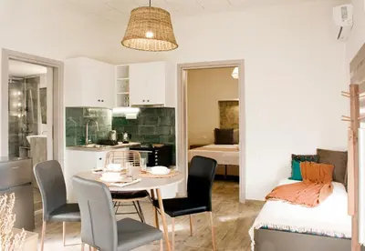 a kitchen and a dining room with a table and chairs at Sia's Sea House in Almirida
