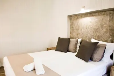 a bedroom with a white bed with two pillows at Sia's Sea House in Almirida