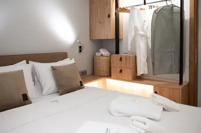 a bedroom with a bed and a large mirror at Anassa Seaside Residence- 50m from Sandy Beach in Chania Town