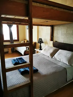 a bedroom with two bunk beds and a lamp at Sweet Home Leo in Chania Town