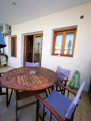 a wooden table and chairs in a room at Sweet Home Leo in Chania Town