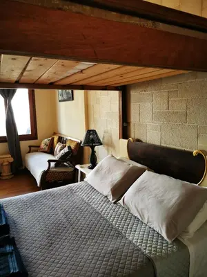 a bedroom with a bed in a room with a brick wall at Sweet Home Leo in Chania Town