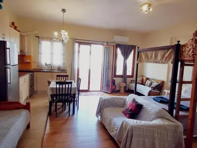 a living room with a couch and a table at Sweet Home Leo in Chania Town