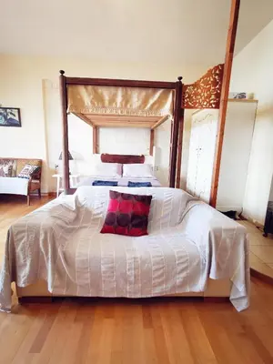 a bedroom with a large white bed with a canopy at Sweet Home Leo in Chania Town