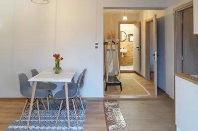 a kitchen and dining room with a table and chairs at Venetian Owl, 1min To Lighthouse in Chania Town
