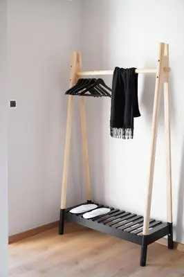 a shelf in a room with a clothes rack at Venetian Owl, 1min To Lighthouse in Chania Town