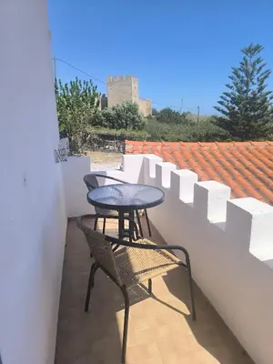 two chairs and a table on a balcony at Artemis Hotel-MeRaki Restaurant in Frangokastello