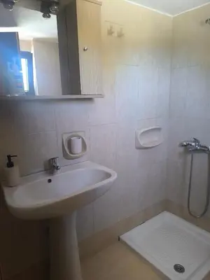 a bathroom with a sink and a shower at Artemis Hotel-MeRaki Restaurant in Frangokastello