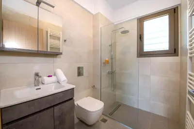 a bathroom with a toilet sink and a shower at Α Ηeaven View Park Gem - Chania Getaway in Chania Town