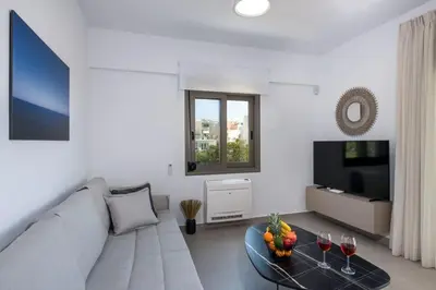 a living room with a couch and a table with wine glasses at Α Ηeaven View Park Gem - Chania Getaway in Chania Town