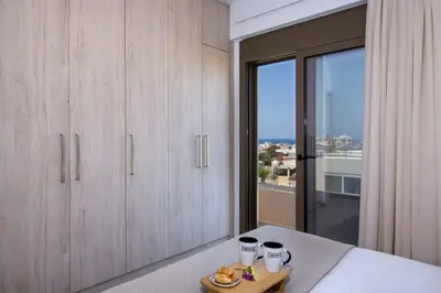 a bedroom with wooden cabinets and a plate of food on a table at Α Ηeaven View Park Gem - Chania Getaway in Chania Town