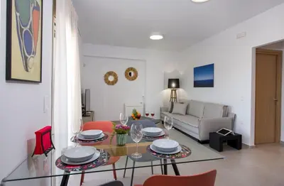 a living room with a glass table and red chairs at A Heaven View Park Hideaway - Chania Nest in Chania Town