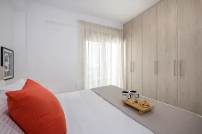 a bedroom with a bed with a tray of food on it at A Heaven View Park Hideaway - Chania Nest in Chania Town